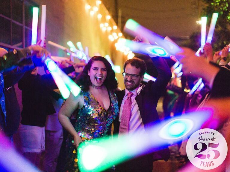Bride and groom dancing at reception with colored light sticks