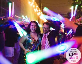 Bride and groom dancing at reception with colored light sticks