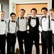 The groomsmen wore suspenders and bow ties with their black tuxedos.