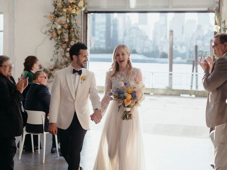 Couple celebrating down aisle