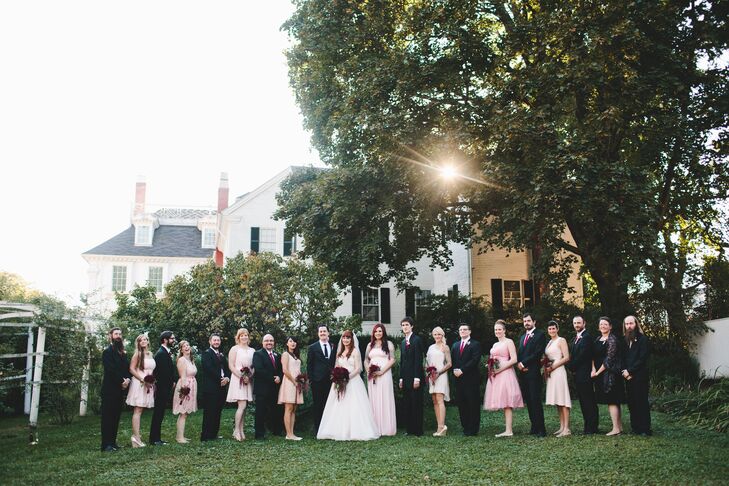 Julia asked each of her eight bridesmaids to select a short, blush pink dress in whatever style made her feel most comfortable. The groomsmen wore their own black, two-piece suits with matching slim red ties from J.Crew.