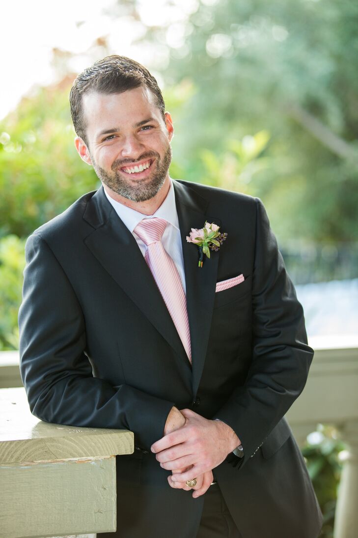 The groom wore a black Canali suit. His groomsmen wore black suits with pink ties.