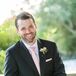 The groom wore a black Canali suit. His groomsmen wore black suits with pink ties.