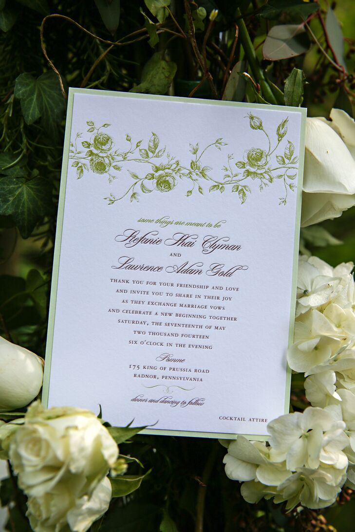 Off-white custom invitations with a sage border and vine motif had text printed in cursive, designed by La Petite Fleur.