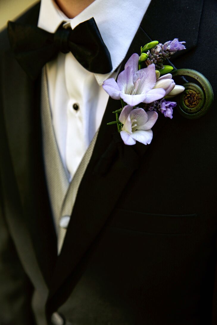 The groom's boutonniere was arranged with freesia, lavender and fiddlehead ferns,  decorated by TableArt.