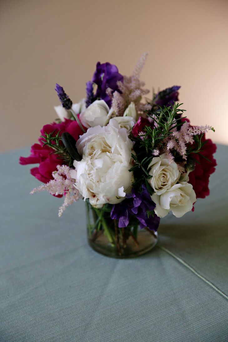Hobnail jars were filled with a mix of roses, pale pink astilbe, skyline ranunculus, white peonies and lilacs.