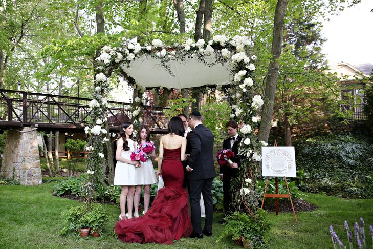 The couple were married under the chuppah surrounded by the stunning wooded area of the front lawn at Pomme. Garland accented with white hydrangeas and majolica spray roses decorated the top beam of the altar, draping onto the four poles.