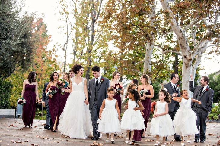 The romantic fall theme carried over into the wedding party’s attire, with Lauren and Phil choosing a dramatic palette of bordeaux and gray for their bridesmaids and groomsmen. The girls donned strapless chiffon gowns for the occasion, while the guys kept it classy in traditional three-piece suits and Bordeaux ties.