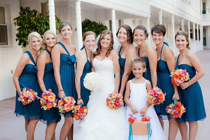 The girls wore dark-teal dresses, some with halter straps, others with just one shoulder strap.