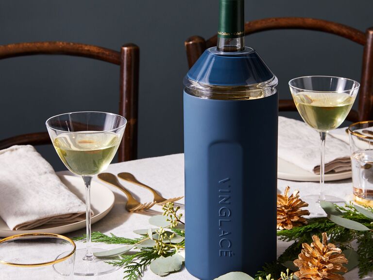 Blue wine chiller on dinner table with two glasses of white wine