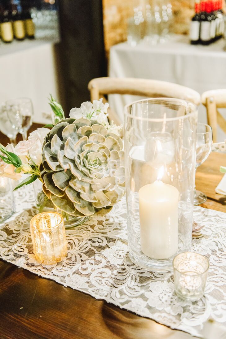 Dining tables had white lace runners draped down the middle, decorated with large succulent arrangements and white candles that gave off a romantic glow.