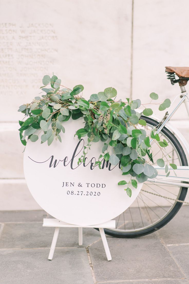 White round sign with eucalyptus accents