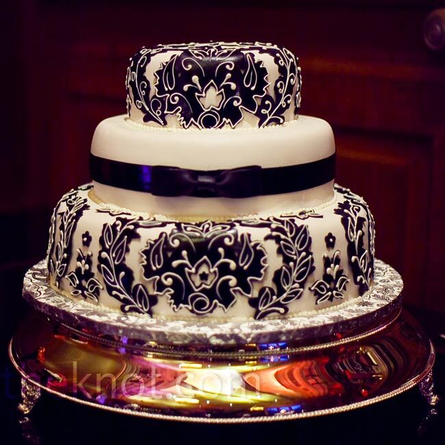 The three-tiered cake was covered in rolled chocolate and decorated with the couple's damask design.