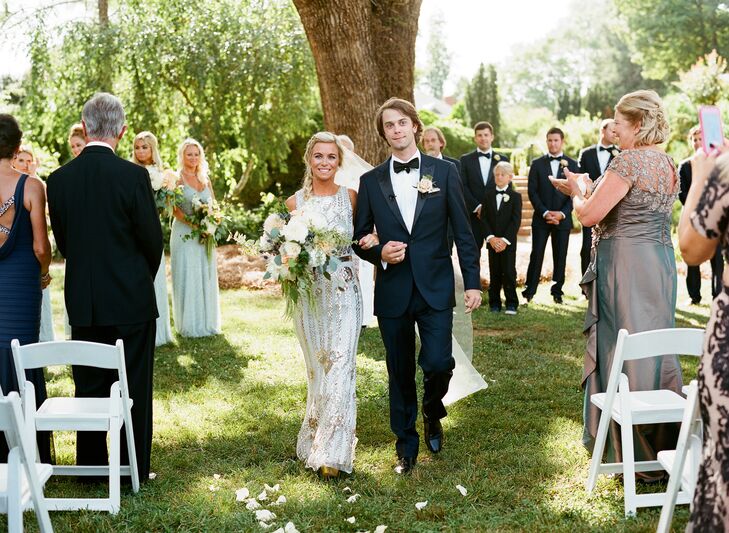 The bride paired her art deco gown with a bouquet of cafe au lait dahlias, white and peach garden roses, thistle, hanging amaranthus and eucalyptus.