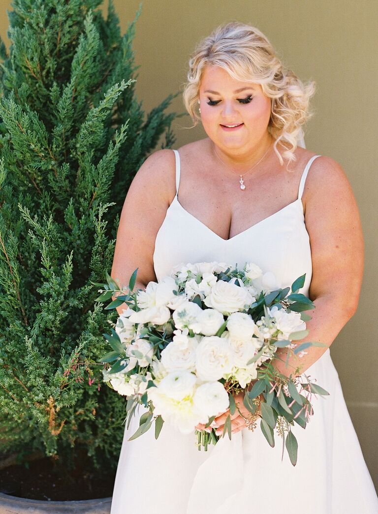 Bride holding textural white wedding bouquet