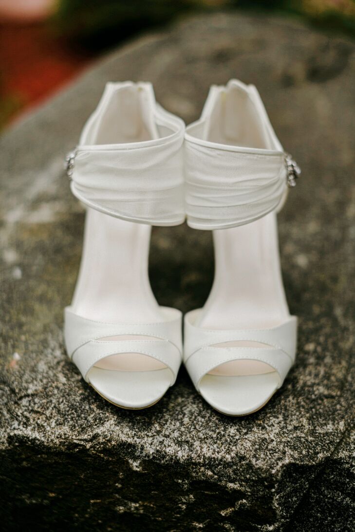 With such a chic Watters dress, Janel elected for classic accessories. She donned a sleek pair of white heels from Macy's. A slight slit above the peep toe gave it a modern touch while sheer, white fabric wrapped around her ankles. The latter even matched her dress's illusion neckline.