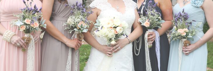 While Jessica carried a white cabbage rose bouquet with pops of coral garden roses and lamb's ear for texture, her bridesmaids had lavender bouquets with baby's breath and the same coral roses and lamb's ear. The bouquets were tied with long lace ribbon for extra vintage detail.