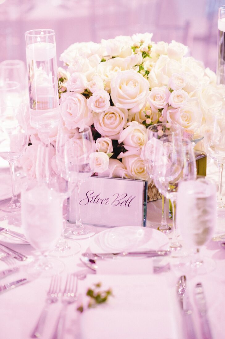 Lush white rose arrangements were placed on each table.