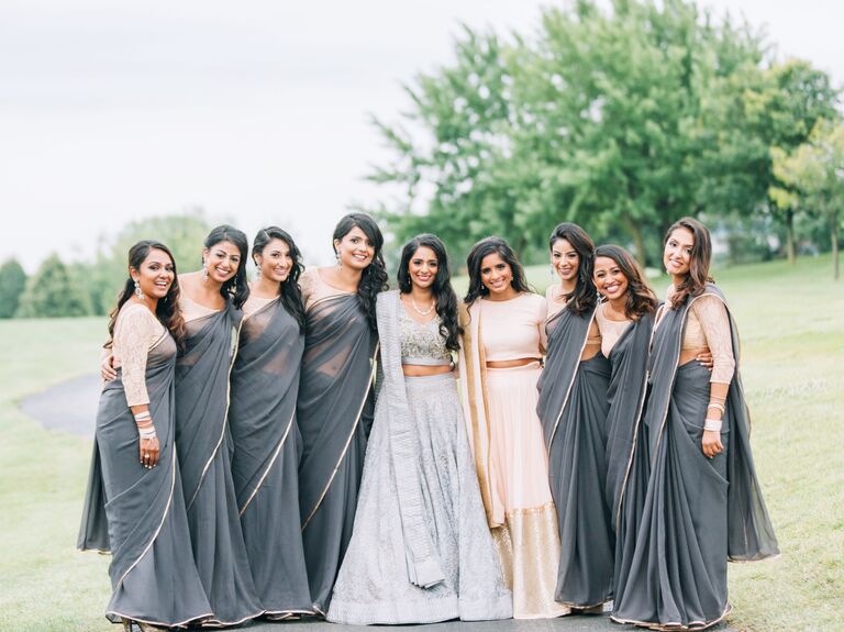 Bridesmaids wearing light weight gray saris for an Indian wedding. 