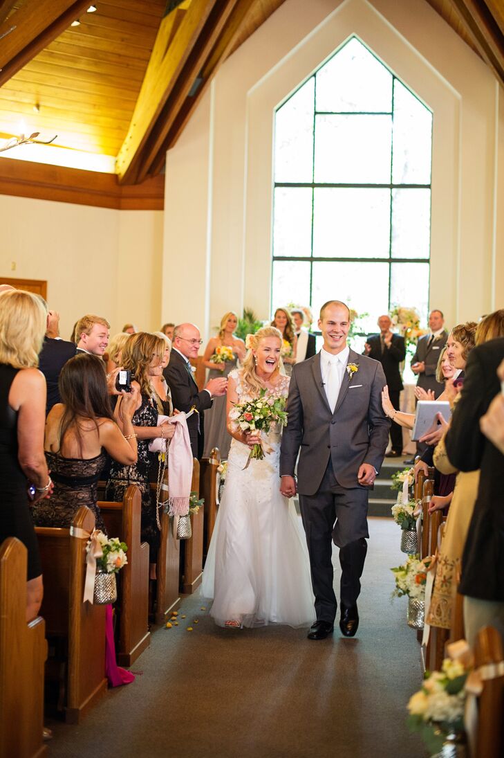 Liz wore a Christos by Amsale A-line wedding dress with crystal and lace detailing and an open back.