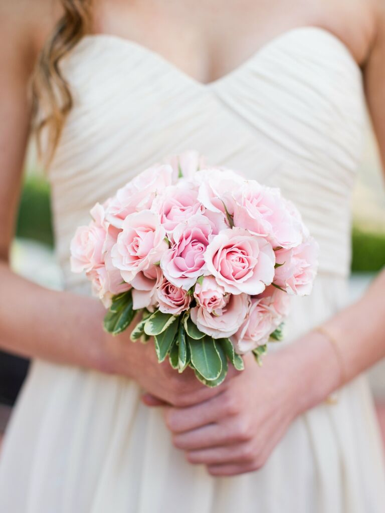A bride holds this springtime-pink bouquet.