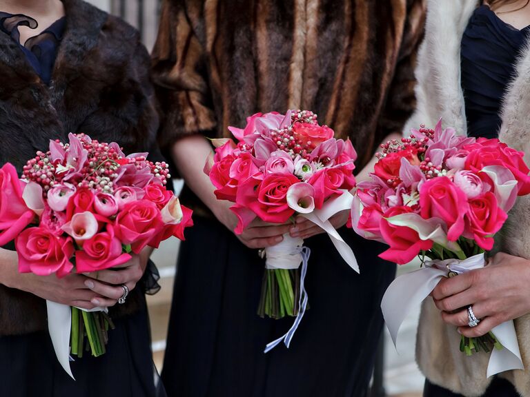 bridesmaids hold pink and purple biedermeier bouquets with roses and calla lilies