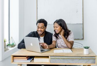 Engaged couple learning how to make wedding registry