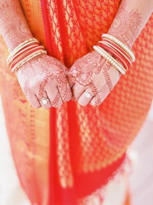 Hand With Henna Wearing Indian Wedding Bracelets