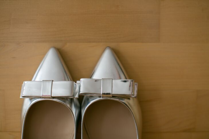 Instead of a traditional heel, the bride opted for metallic silver bow flats from J. Crew.