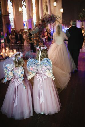 Flower Girls in Pink Dresses, Flower Crowns and Fairy Wings Follow the Bride