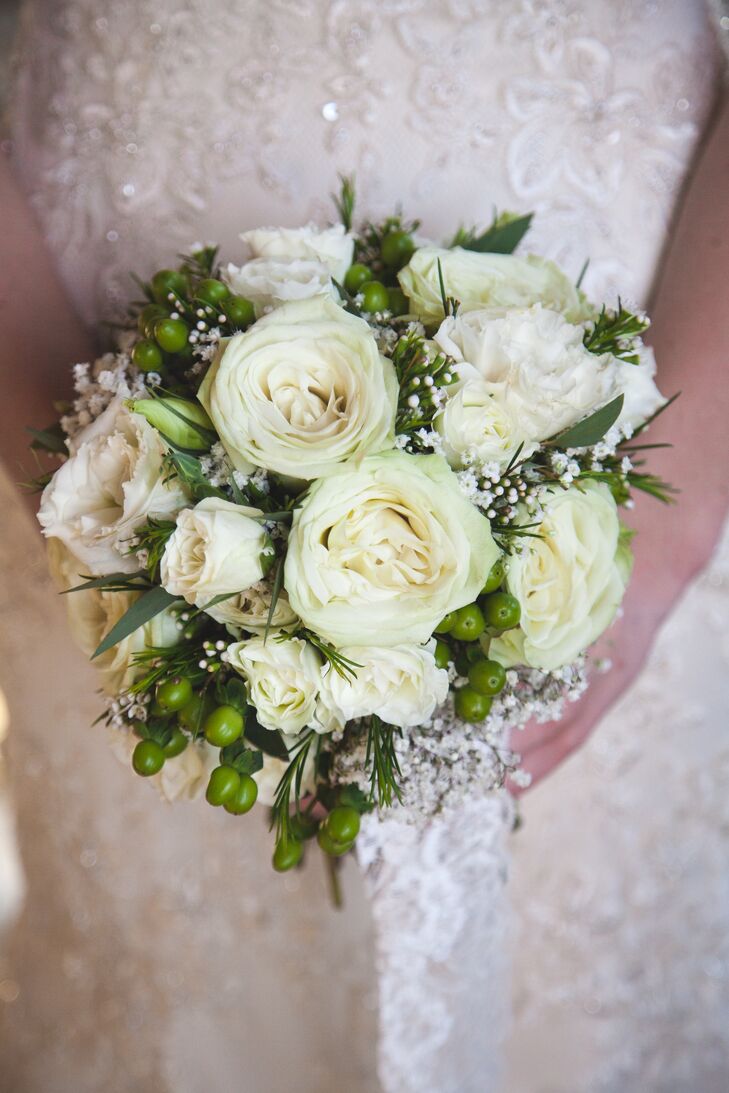 Kira carried white roses, baby’s breath and hypericum berries in her white and green bouquet. 
