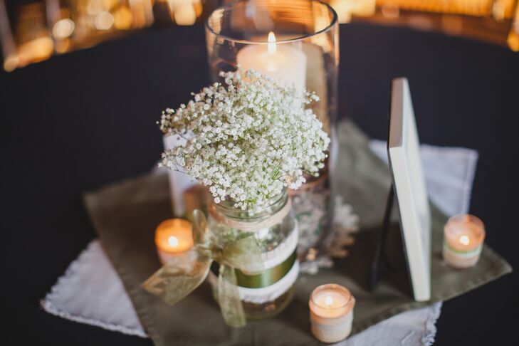 Mason jars were filled with baby’s breath and displayed on the reception tables with pillar candles.
