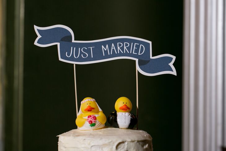 Quirky cake toppers added a fun touch to the couple's homemade wedding cake.
