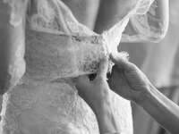 Bride gets ready for wedding day. Wedding dress sizing. 