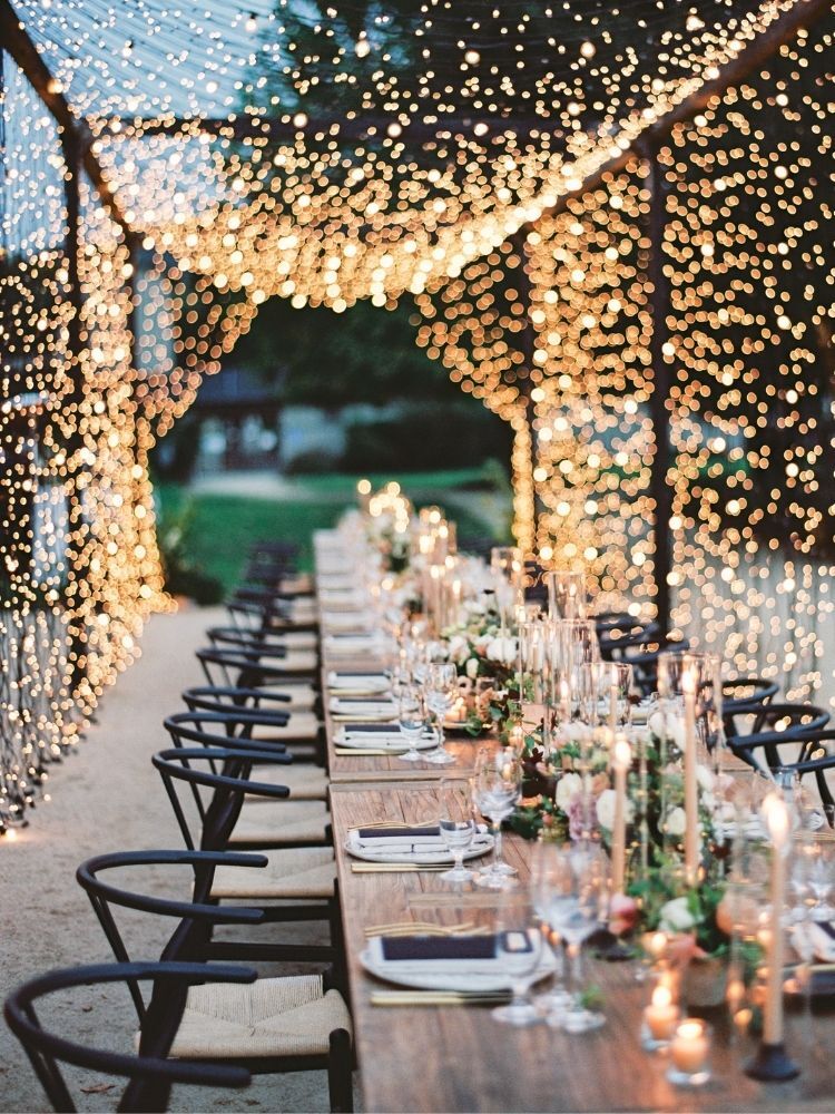 wedding reception dinner table under canopy of twinkle lights