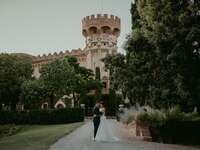 Bride and groom posing at dark academia castle wedding venue