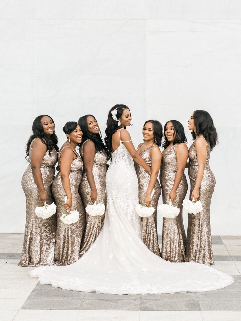 A bride and her wedding party hold gorgeous white bouquets.