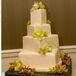 Hand-painted vines and fresh cymbidium orchids covered the four-tiered cake.