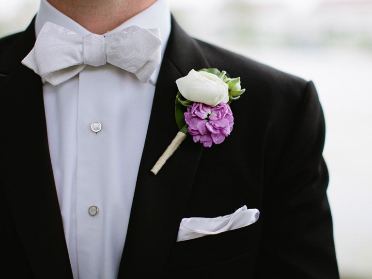 purple camellia and white rose boutonniere