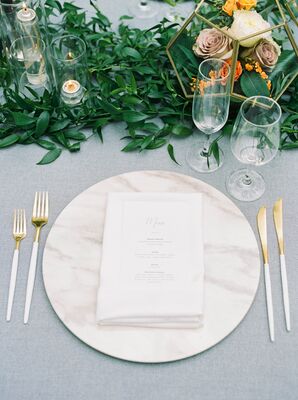 Elegant Place Setting with Menu, Gold Flatware and Marble Charger