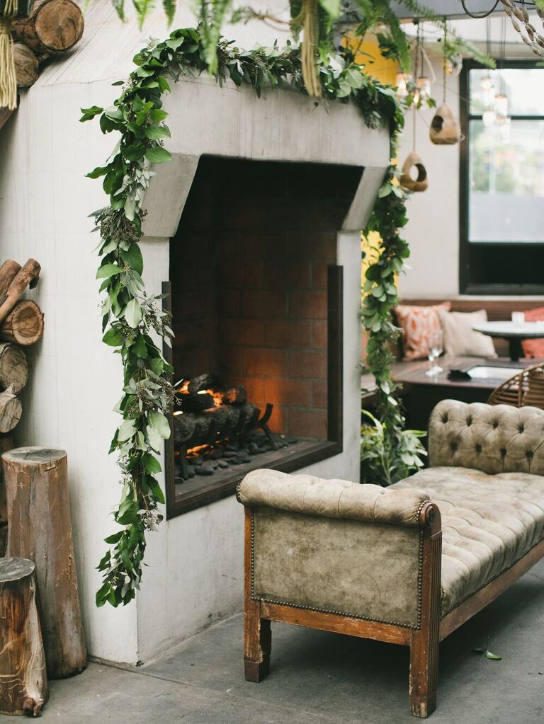 simple wedding fireplace decor idea with greenery garland