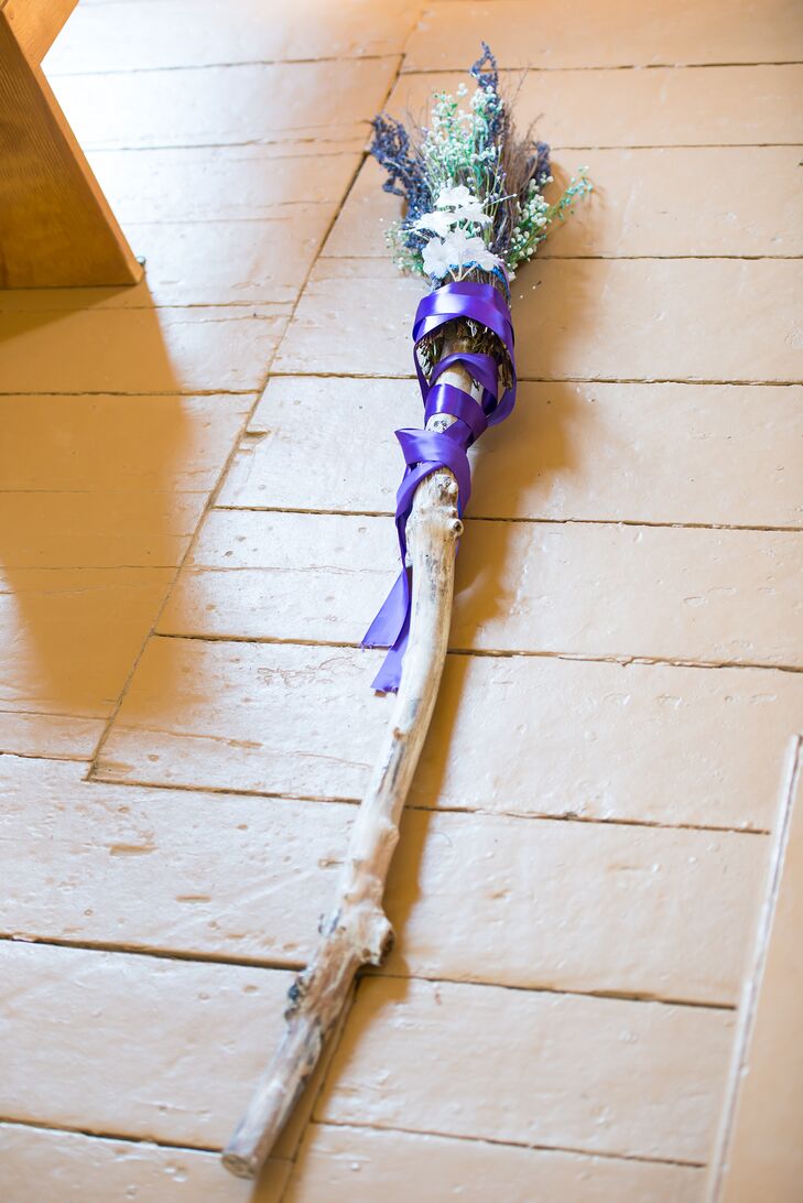The couple performed a traditional "jump the broom" ceremony at their wedding, jumping over a broom decorated with fresh flowers and a long purple satin ribbon.