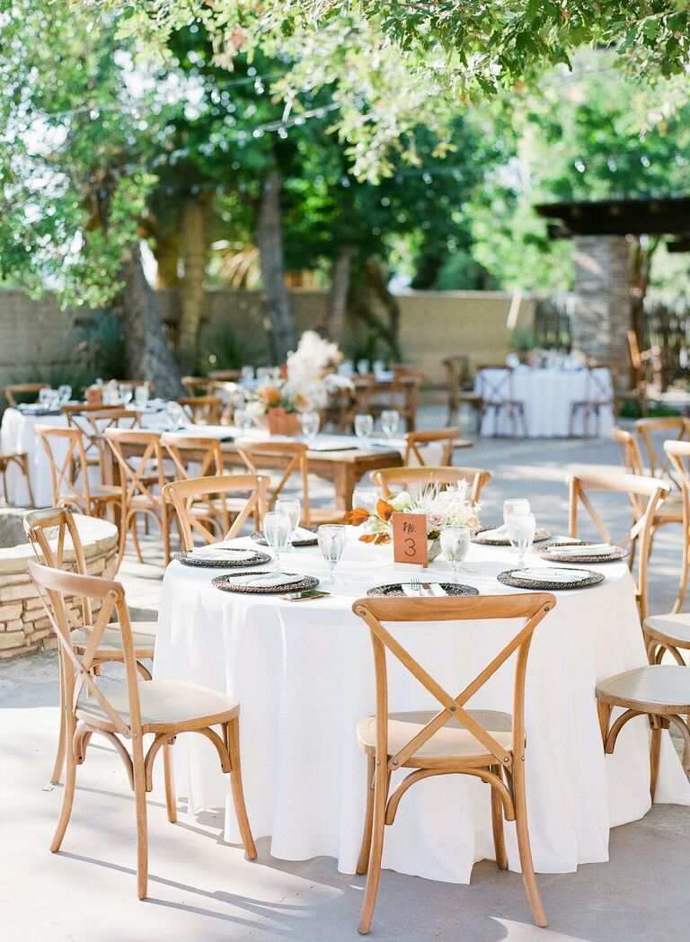 Rustic wedding reception decor with cross-back chairs