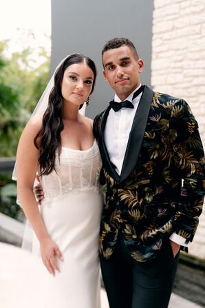Bride With Beachy Waves Posing With Groom in Black-and-Gold Tuxedo