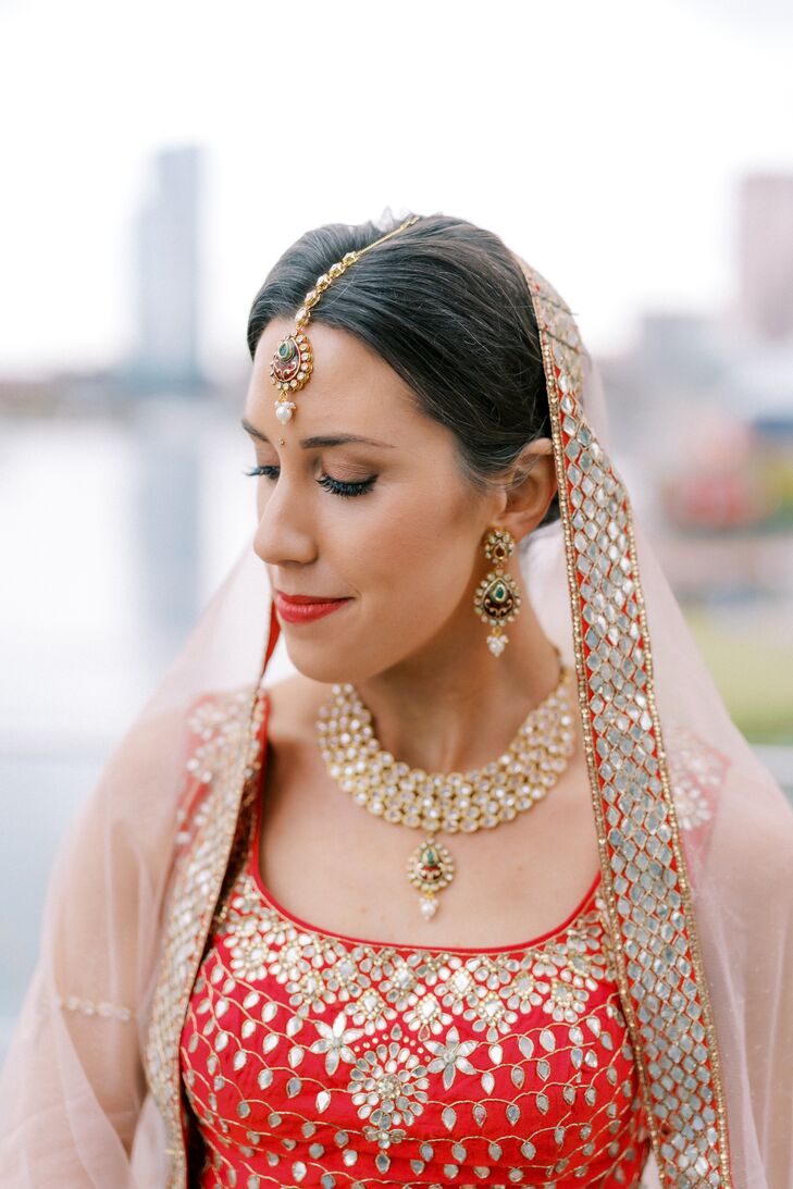 Bride Wearing Indian Wedding Attire With Veil and Maang Tikka Hair Accessory