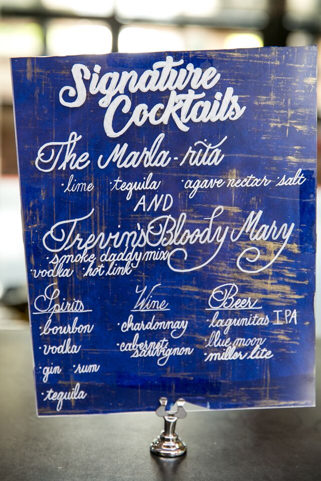 His and hers cocktails were the Marla-rita and Trevin’s Bloody Mary. The cocktails were displayed on a blue wooden sign.