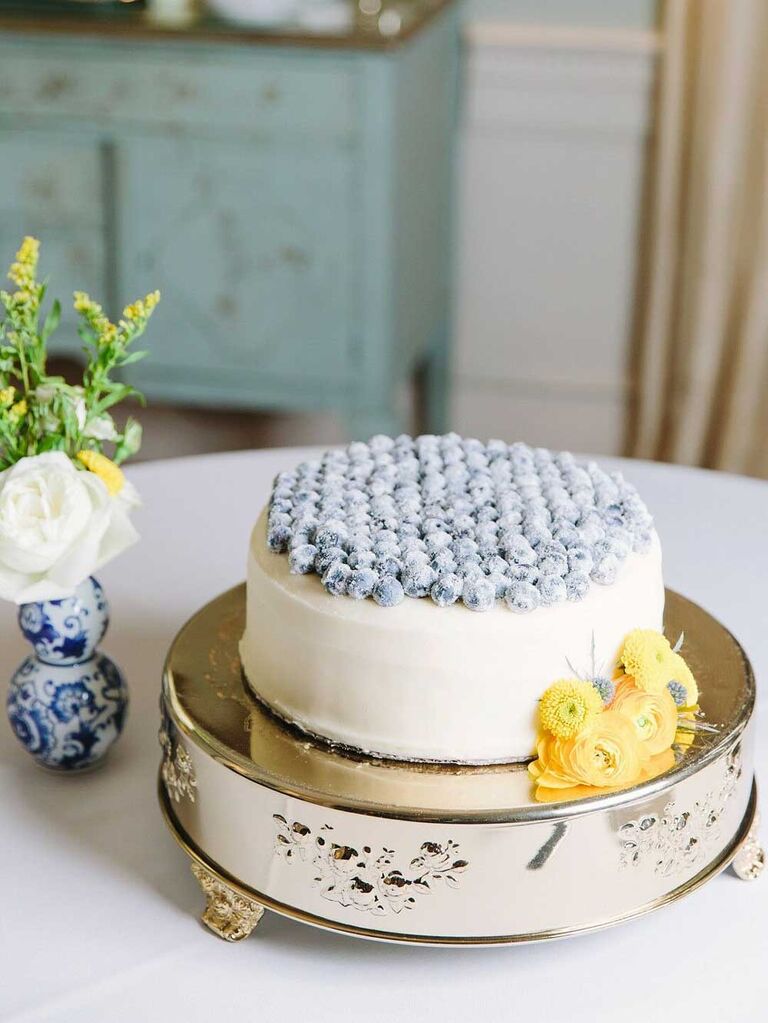 Small one-tier wedding cake with blueberries on top