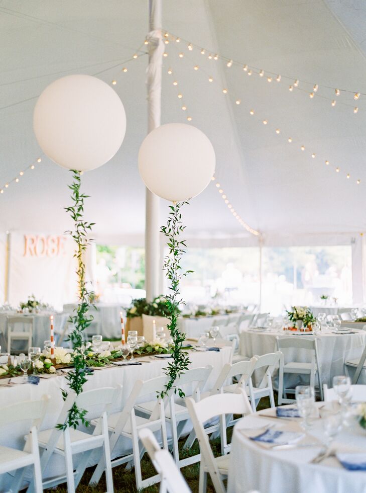 In lieu of garlands or classic “Mr. and Mrs.” signs to distinguish their seats, Christine and Addison decorated their chairs with Geronimo balloons wrapped in vines of ivy. Birds of a Flower also built a giant cluster of balloons to hang over the dance floor for a festive touch.