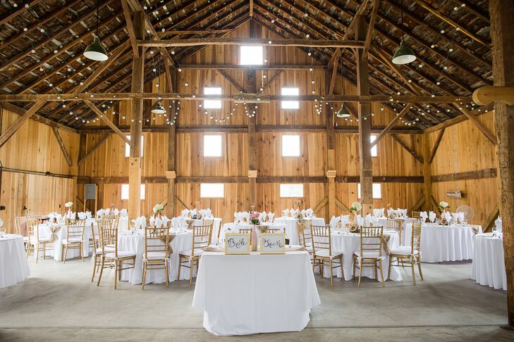 Crisp white linens and gold chiavari chairs decorated the round reception tables.