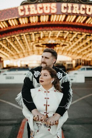 Couple in Western Fringe Attire Posing for Portraits in Las Vegas During Vow Renewal